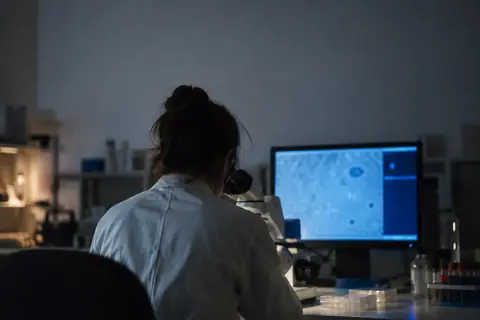 A scientist at a microscope