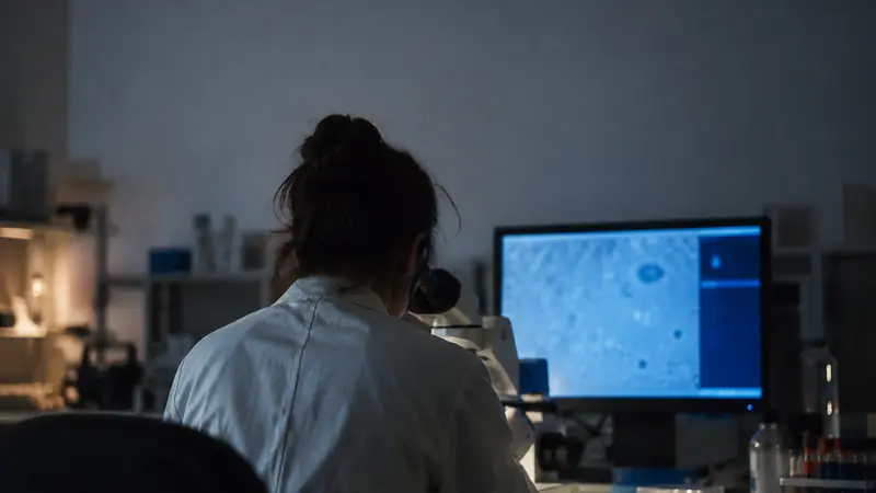 A scientist at a microscope